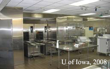 Another view of the decontamination room showing the large automated washing machines that connect to the clean side of the facility